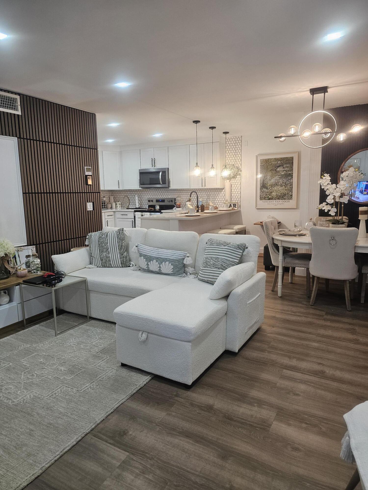 312 Pine Ridge Circle, Unit A2 Greenacres, FL 33463 - Photo 67 of 73 a living room with furniture and a wooden floor