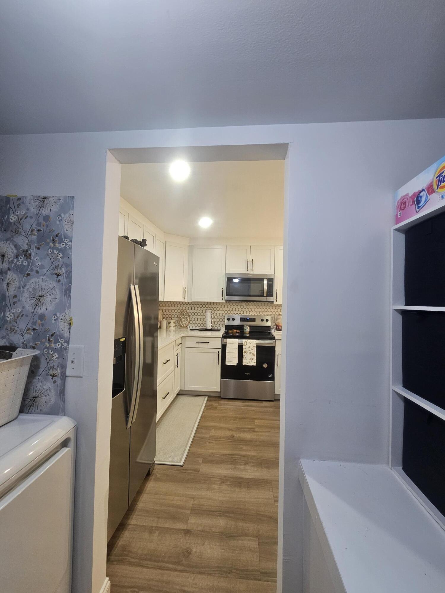 312 Pine Ridge Circle, Unit A2 Greenacres, FL 33463 - Photo 68 of 73 a kitchen with stainless steel appliances a refrigerator and a stove top oven