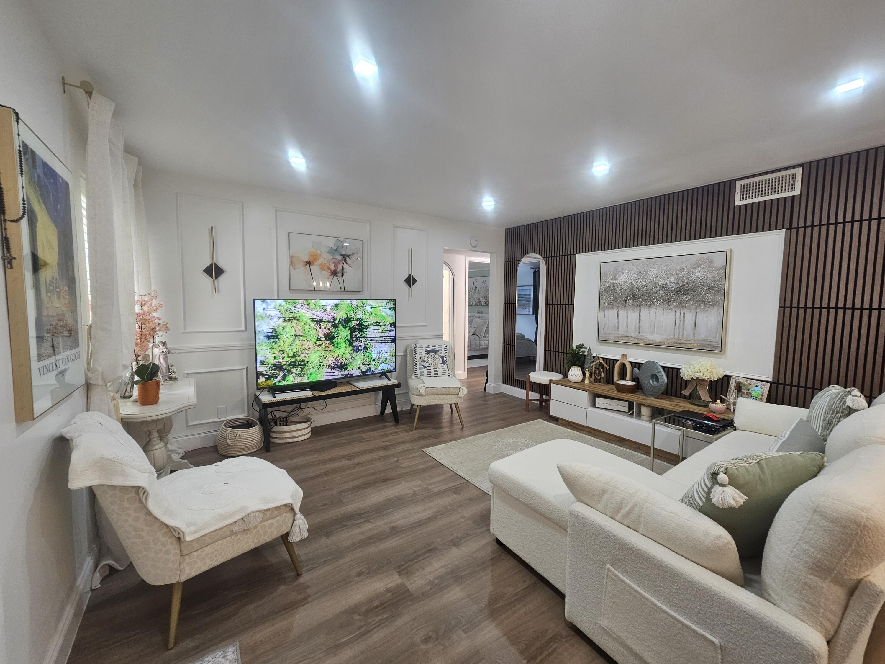 312 Pine Ridge Circle, Unit A2 Greenacres, FL 33463 - Photo 10 of 73 a living room with furniture and a flat screen tv