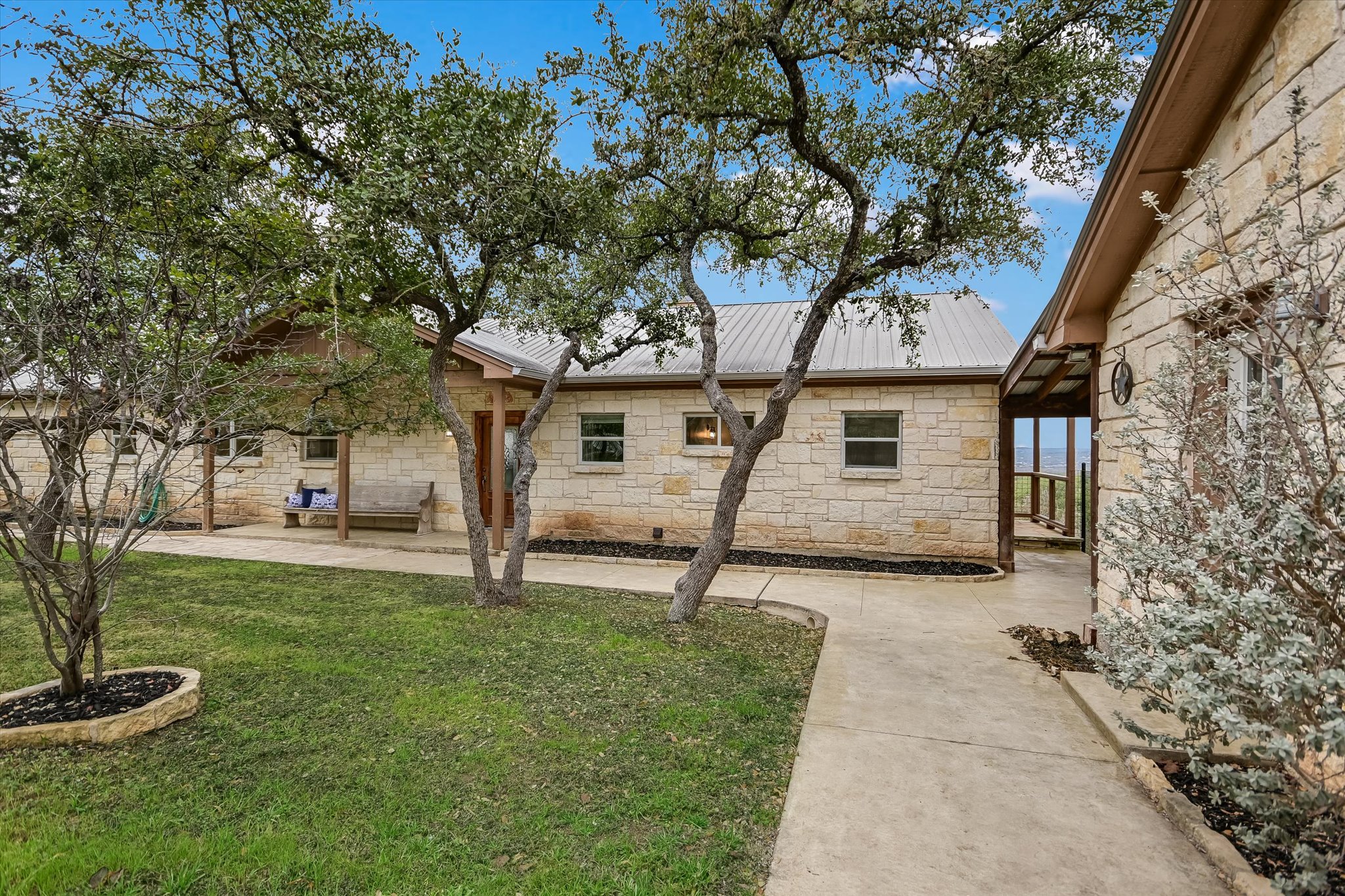 816 Buttercup Lane Wimberley, TX 78676 - Photo 5 of 36 a white house that has a tree in front of it