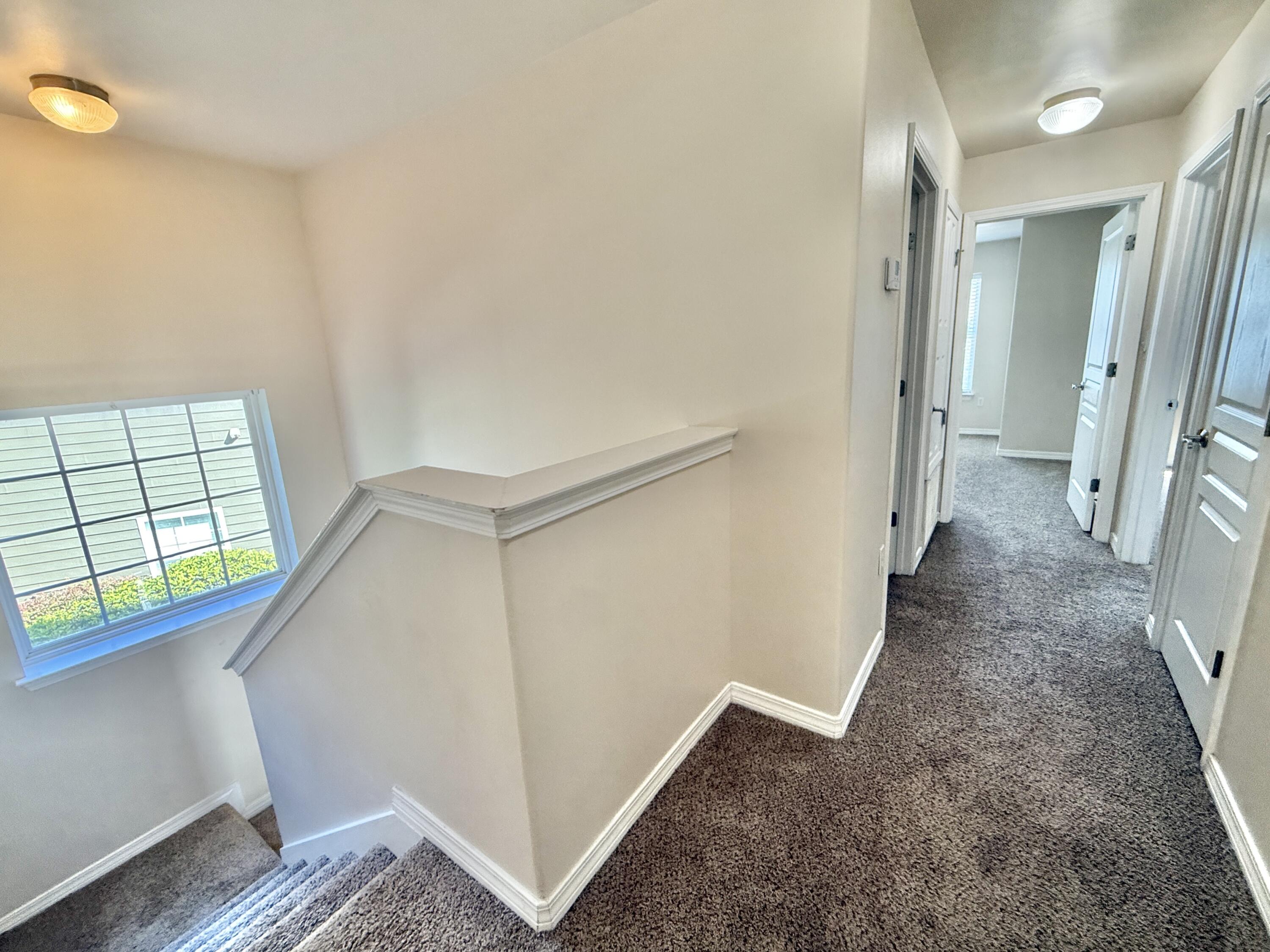197 Hackberry Way Santa Rosa Beach, FL 32459 - Photo 24 of 26 a view of a hallway with wooden cabinets and staircase