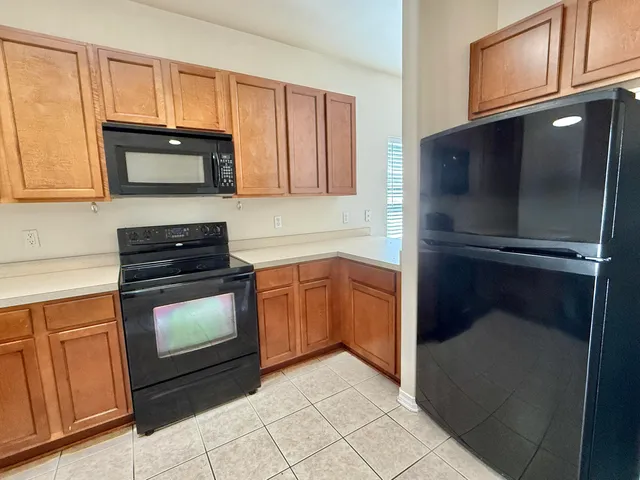 a kitchen with granite countertop cabinets and steel stainless steel appliances