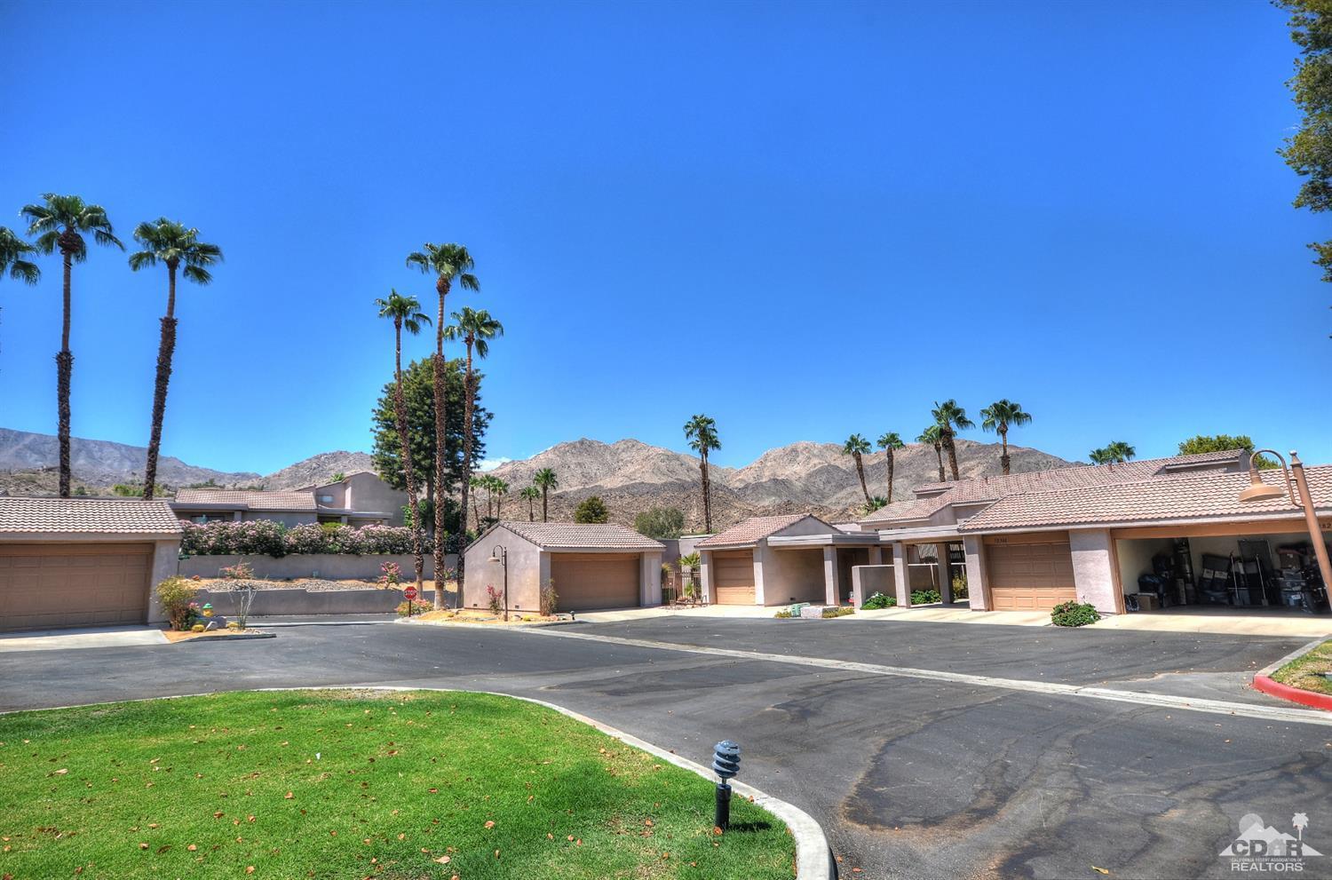 72386 Ridgecrest Lane Palm Desert, CA 92260 - Photo 2 of 38 a front view of a house with a garden and plants