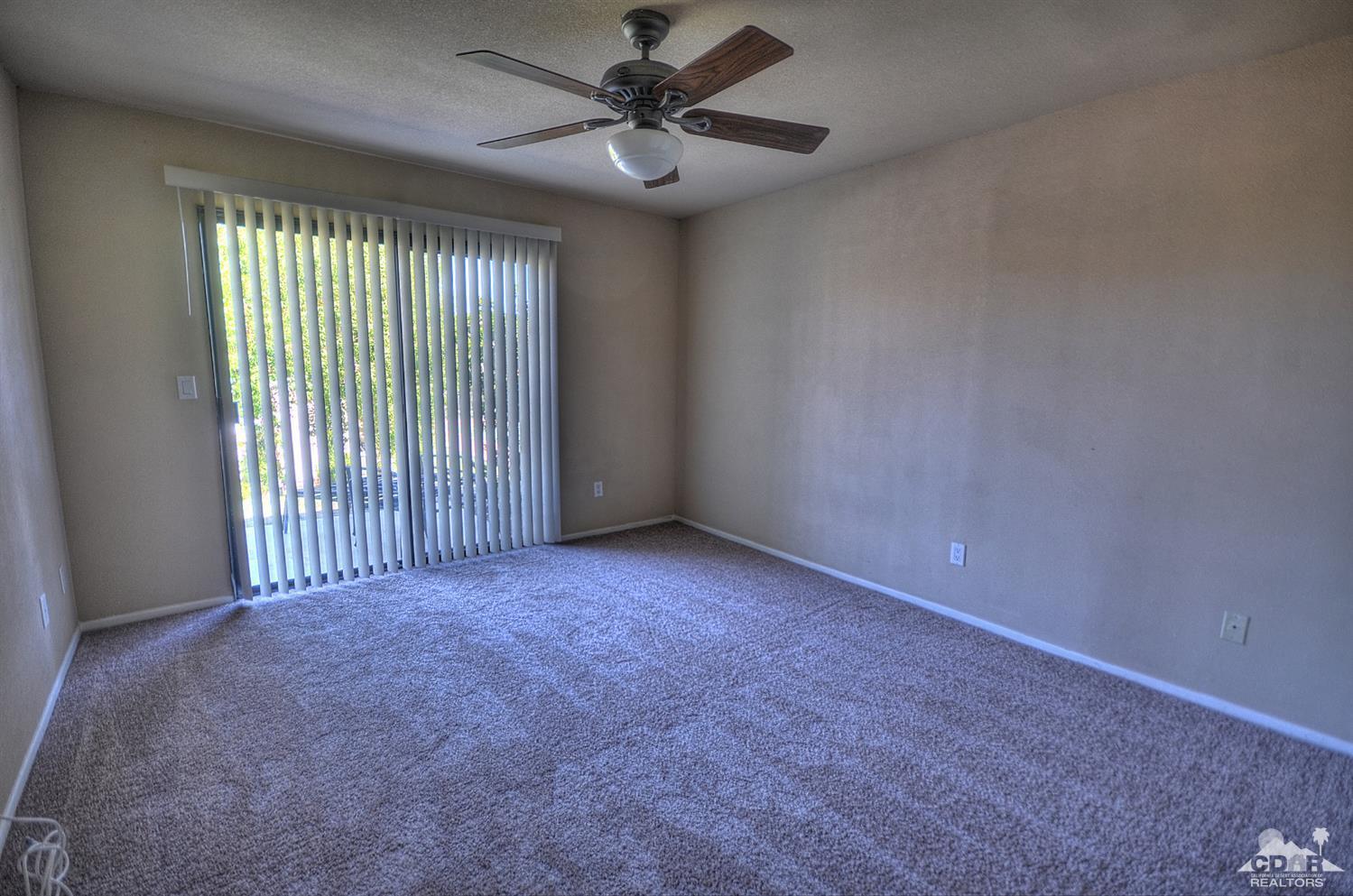 72386 Ridgecrest Lane Palm Desert, CA 92260 - Photo 19 of 38 an empty room with windows and fan