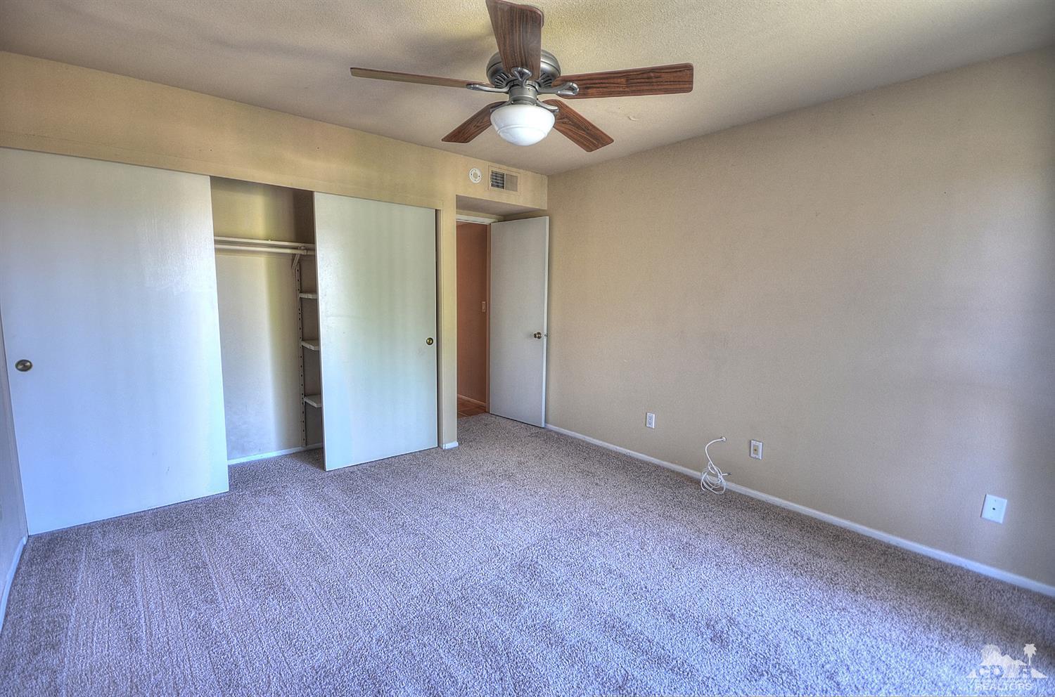 72386 Ridgecrest Lane Palm Desert, CA 92260 - Photo 21 of 38 an empty room with closet and a ceiling fan