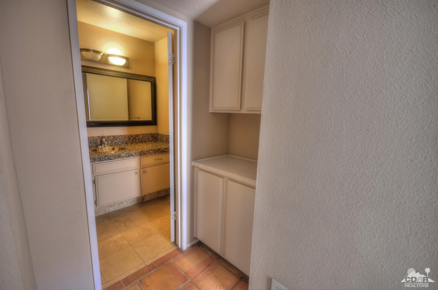 72386 Ridgecrest Lane Palm Desert, CA 92260 - Photo 22 of 38 a hallway with a stove and a microwave