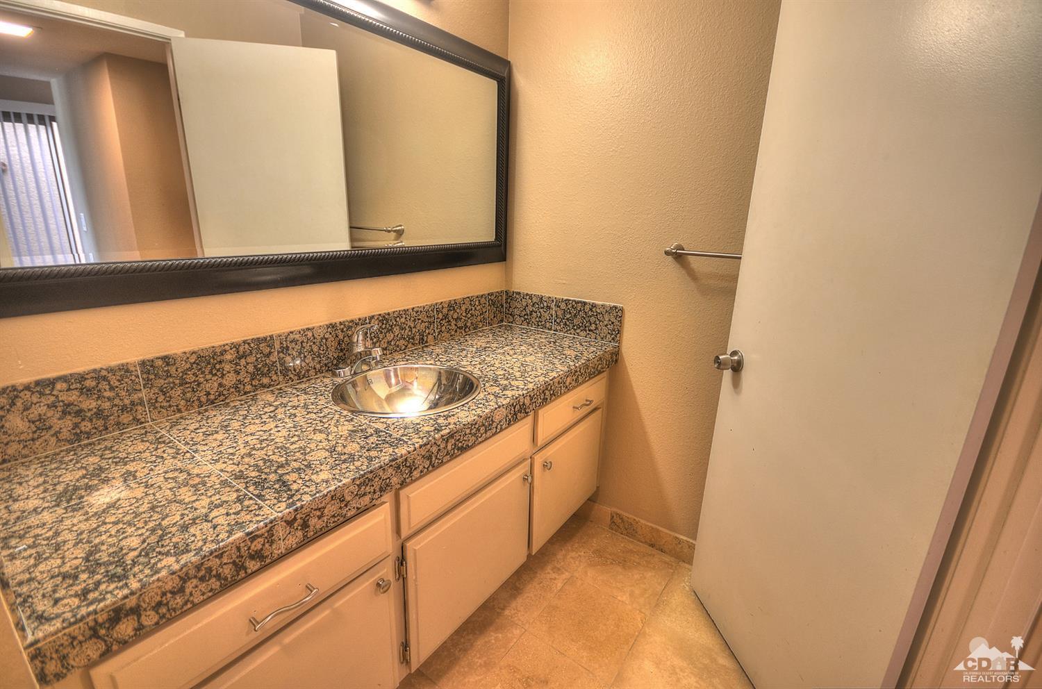 72386 Ridgecrest Lane Palm Desert, CA 92260 - Photo 23 of 38 a bathroom with a sink and a mirror