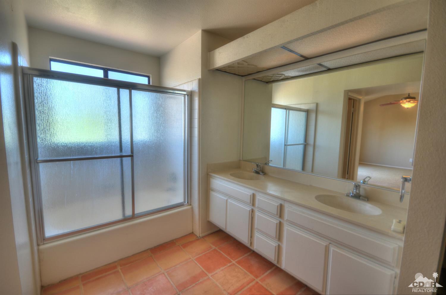 72386 Ridgecrest Lane Palm Desert, CA 92260 - Photo 27 of 38 a bathroom with a double vanity sink mirror and shower