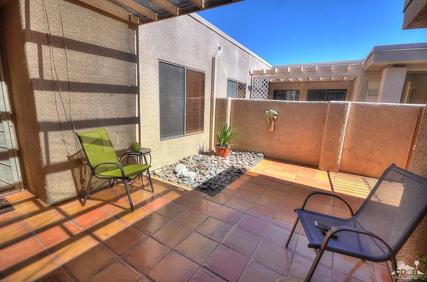 72386 Ridgecrest Lane Palm Desert, CA 92260 - Photo 4 of 38 a backyard of a house with table and chairs