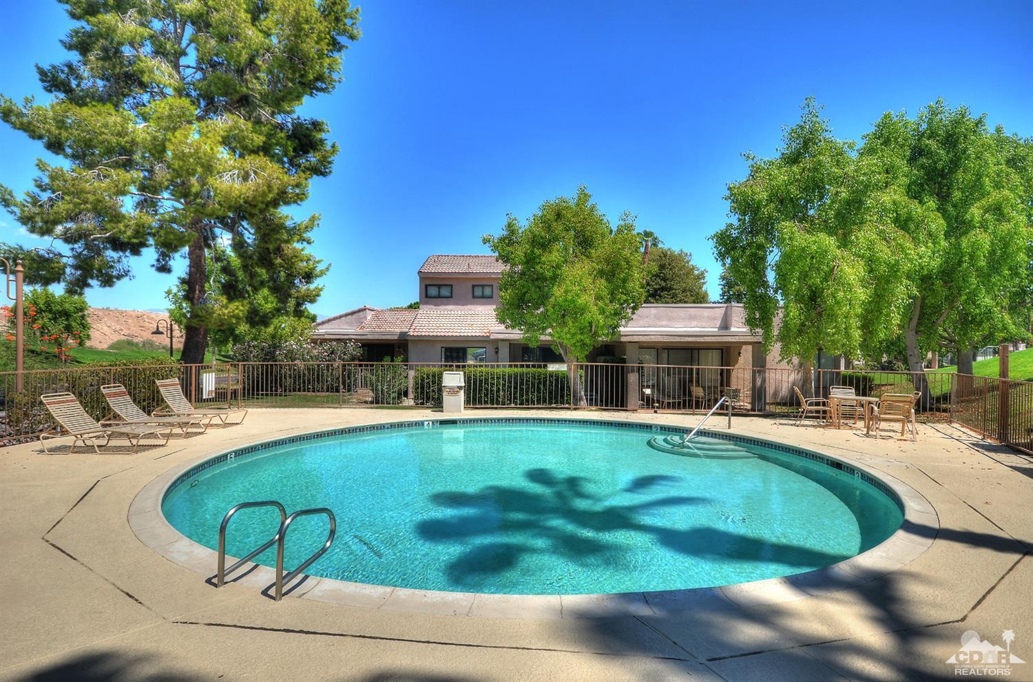 72386 Ridgecrest Lane Palm Desert, CA 92260 - Photo 35 of 38 a view of a swimming pool with lounge chairs