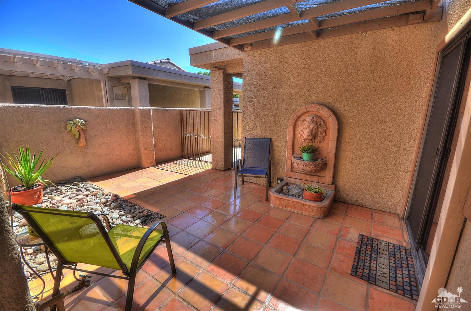 72386 Ridgecrest Lane Palm Desert, CA 92260 - Photo 5 of 38 a backyard of a house with table and chairs