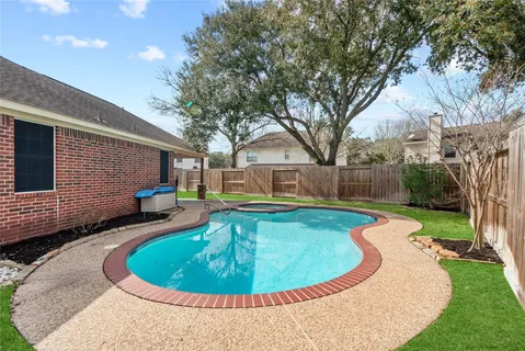 a view of a swimming pool with back yard