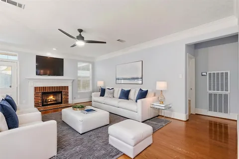 a living room with furniture a fireplace and a flat screen tv