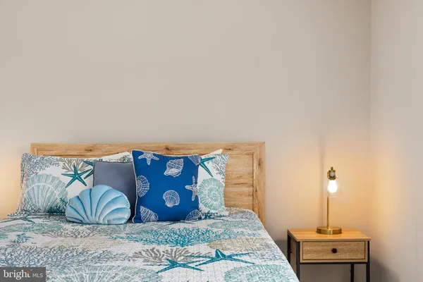 a bedroom with a bed and a night stand