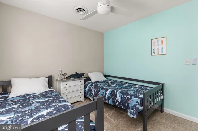 a kitchen with stainless steel appliances a refrigerator a sink a stove and white cabinets