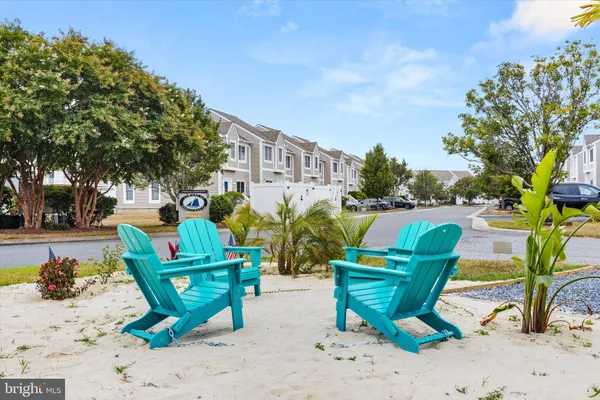 an aerial view of a city with lots of residential buildings ocean and mountain view in back