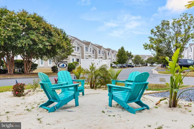 an aerial view of a city with lots of residential buildings ocean and mountain view in back