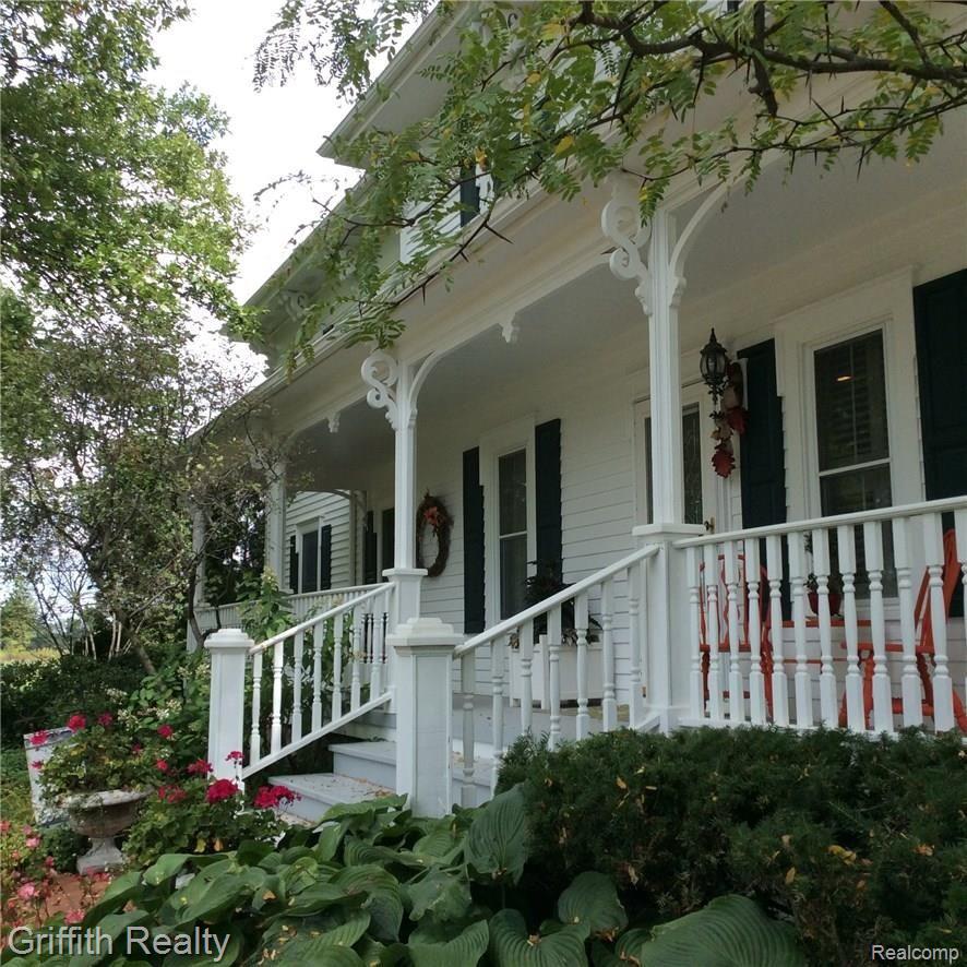 2240 North Eager Road Howell, MI 48855 - Photo 2 of 34 Wrap around porch with several entrances to this dynamic home.