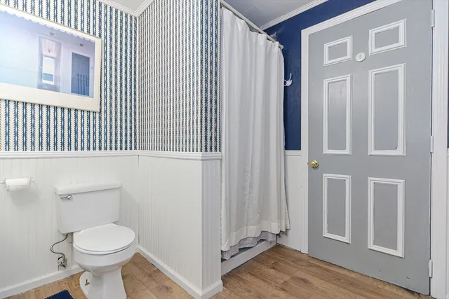 a bathroom with a toilet a sink and a window