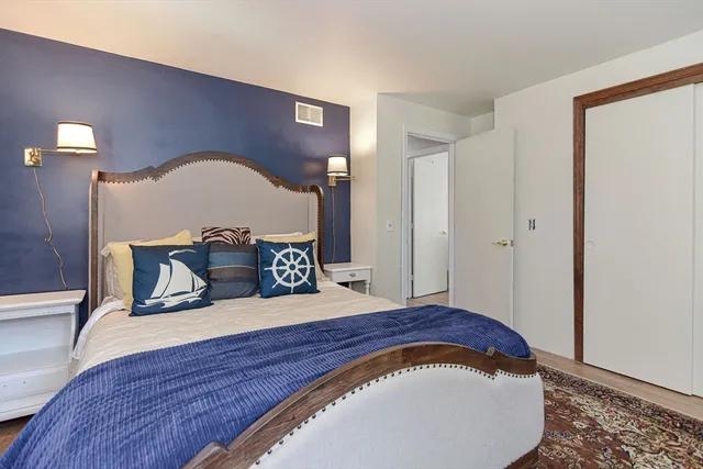 a bedroom with a bed and a potted plant