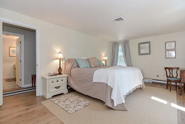 a spacious bedroom with a bed and a desk