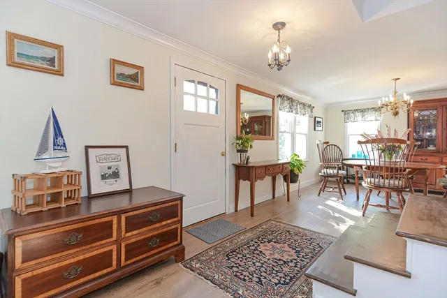 a living room with furniture a dining table and a window