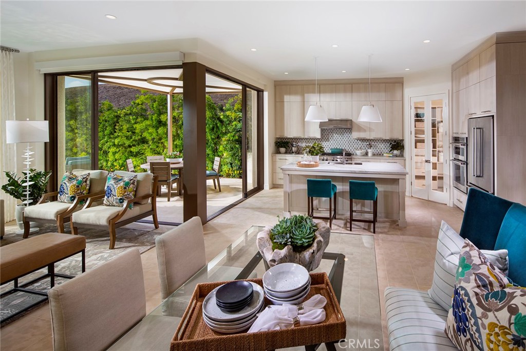 105 Thimbleberry, Unit 76 Irvine, CA 92618 - Photo 2 of 5 a living room with furniture and a large window