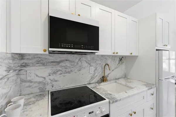 a kitchen with a stove and a microwave