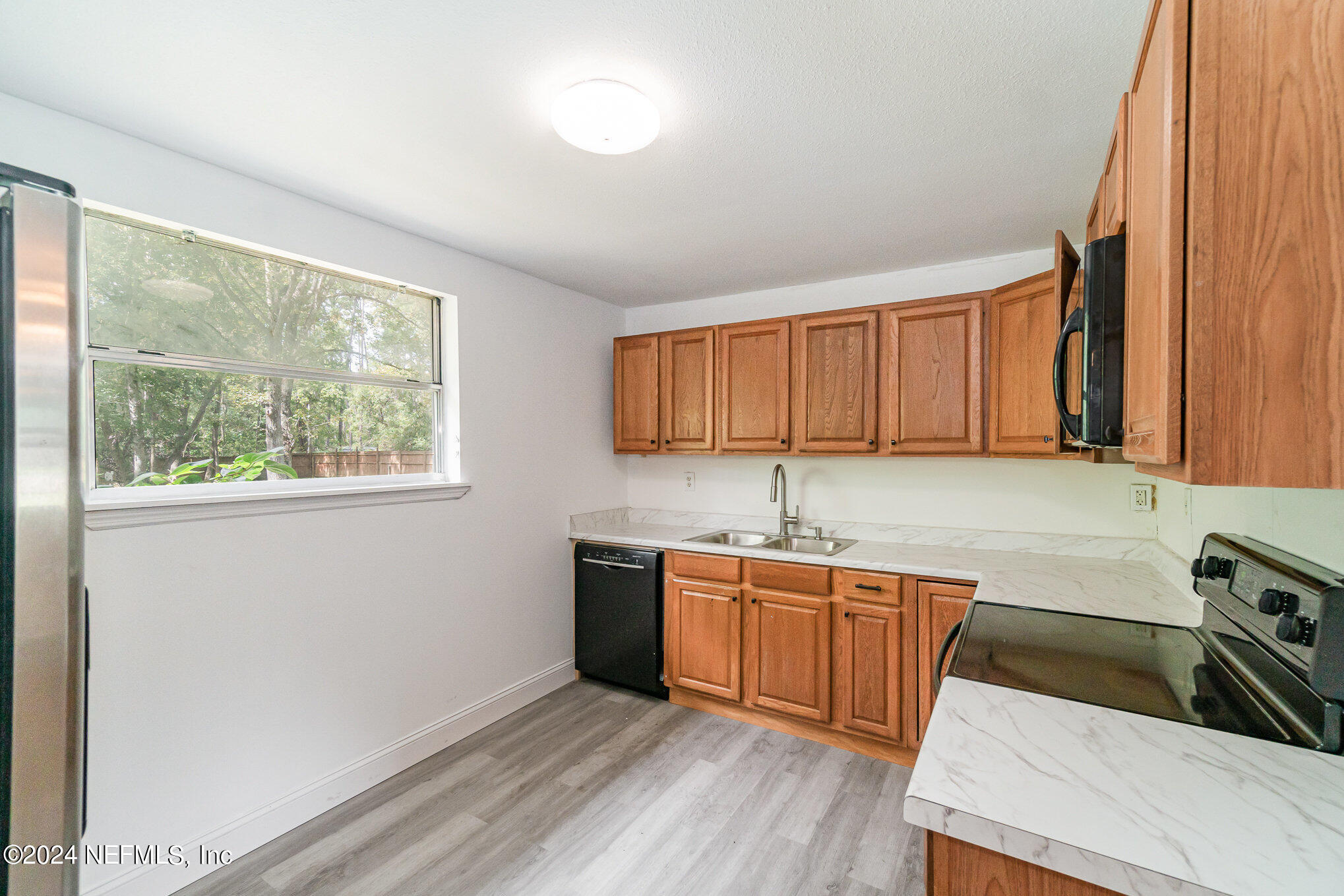 1108 Blair Road Jacksonville, FL 32221 - Photo 12 of 30 a kitchen with stainless steel appliances granite countertop a sink stove and cabinets
