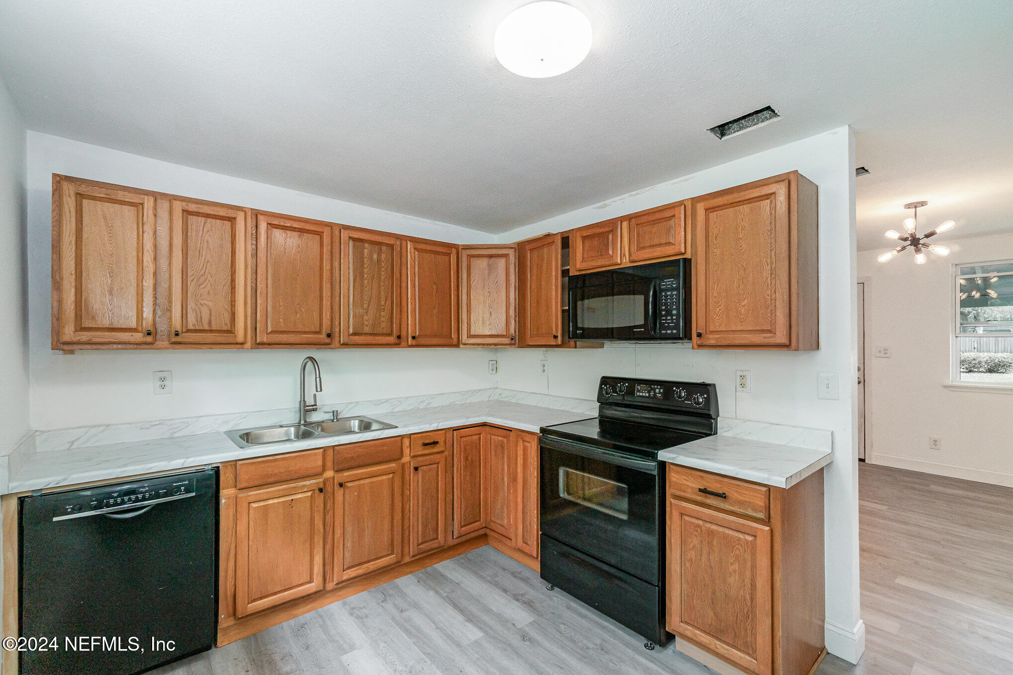 1108 Blair Road Jacksonville, FL 32221 - Photo 13 of 30 a kitchen with stainless steel appliances granite countertop a sink stove and microwave