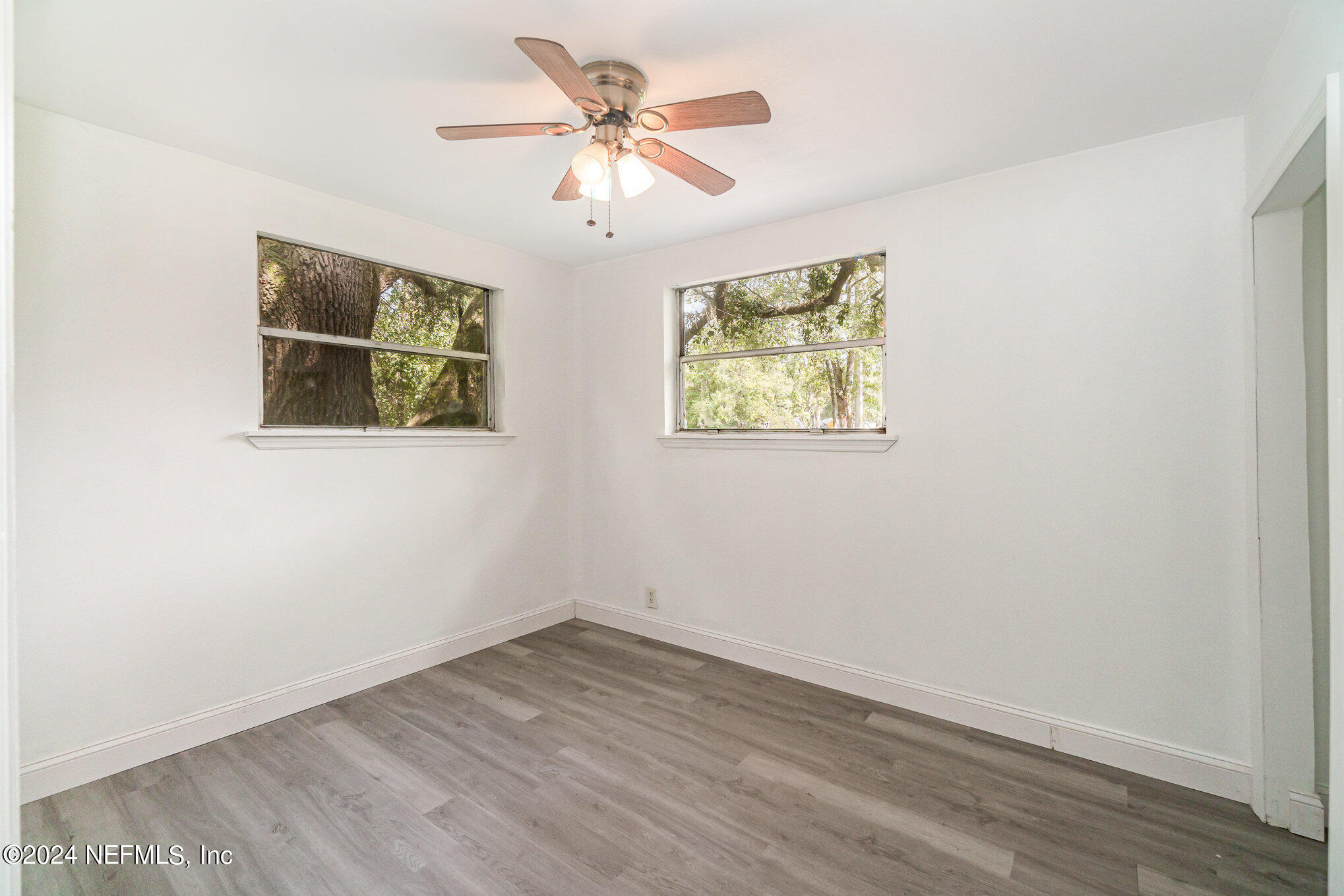 1108 Blair Road Jacksonville, FL 32221 - Photo 16 of 30 an empty room with wooden floor and ceiling fan