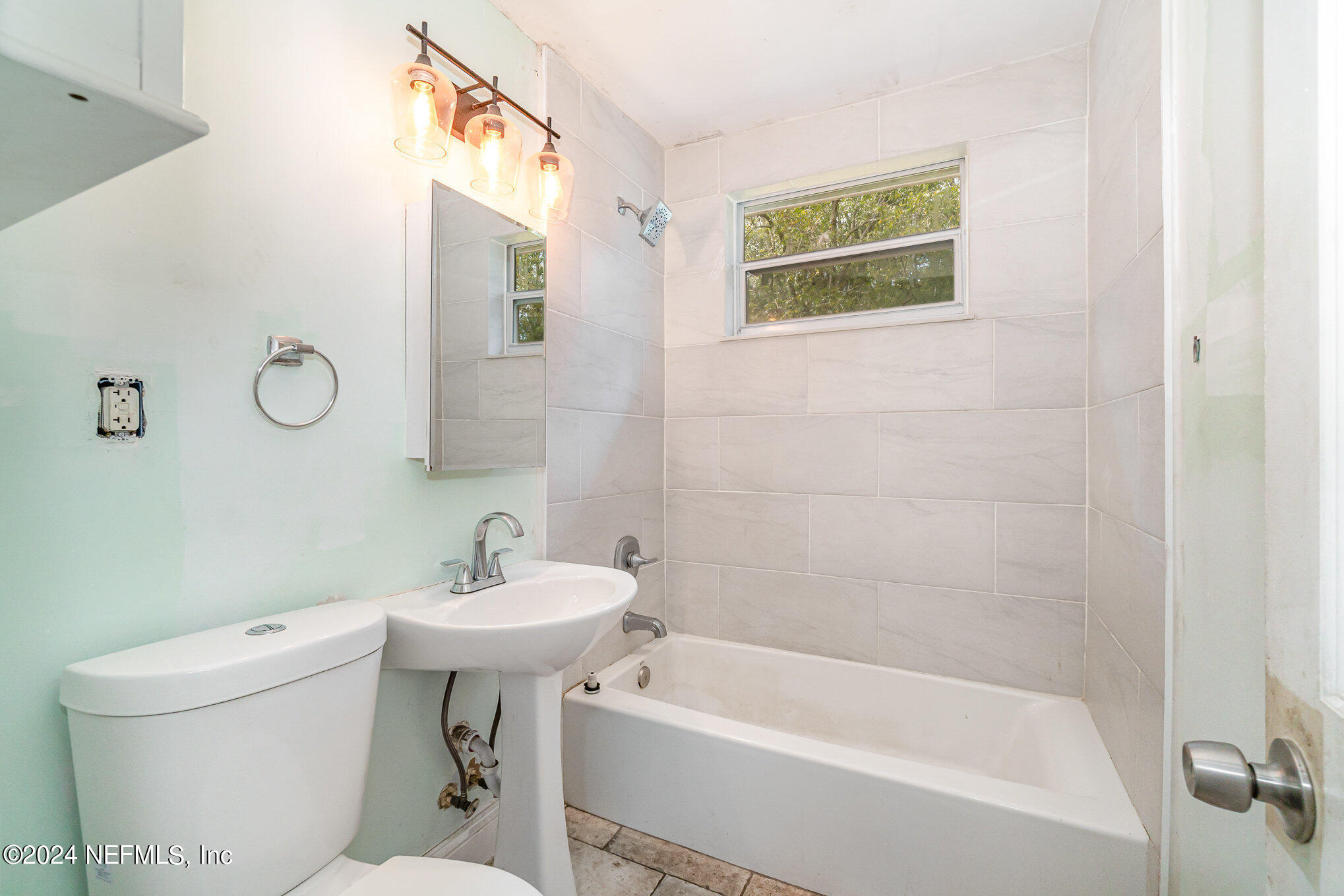 1108 Blair Road Jacksonville, FL 32221 - Photo 18 of 30 a white bath tub sitting next to a white toilet and a sink