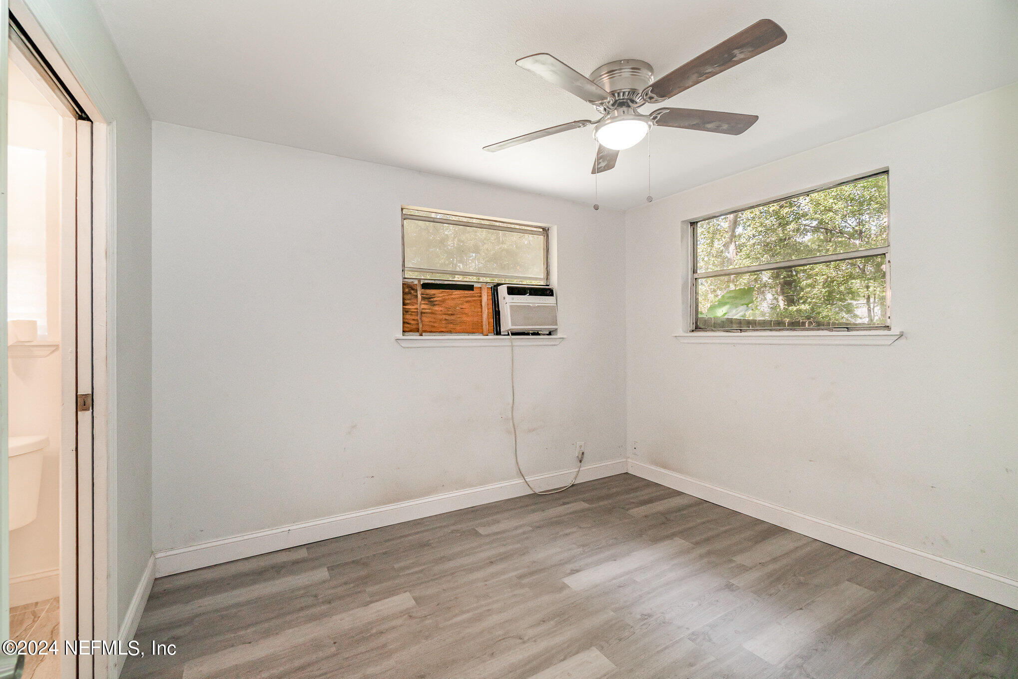 1108 Blair Road Jacksonville, FL 32221 - Photo 19 of 30 an empty room with wooden floor and windows