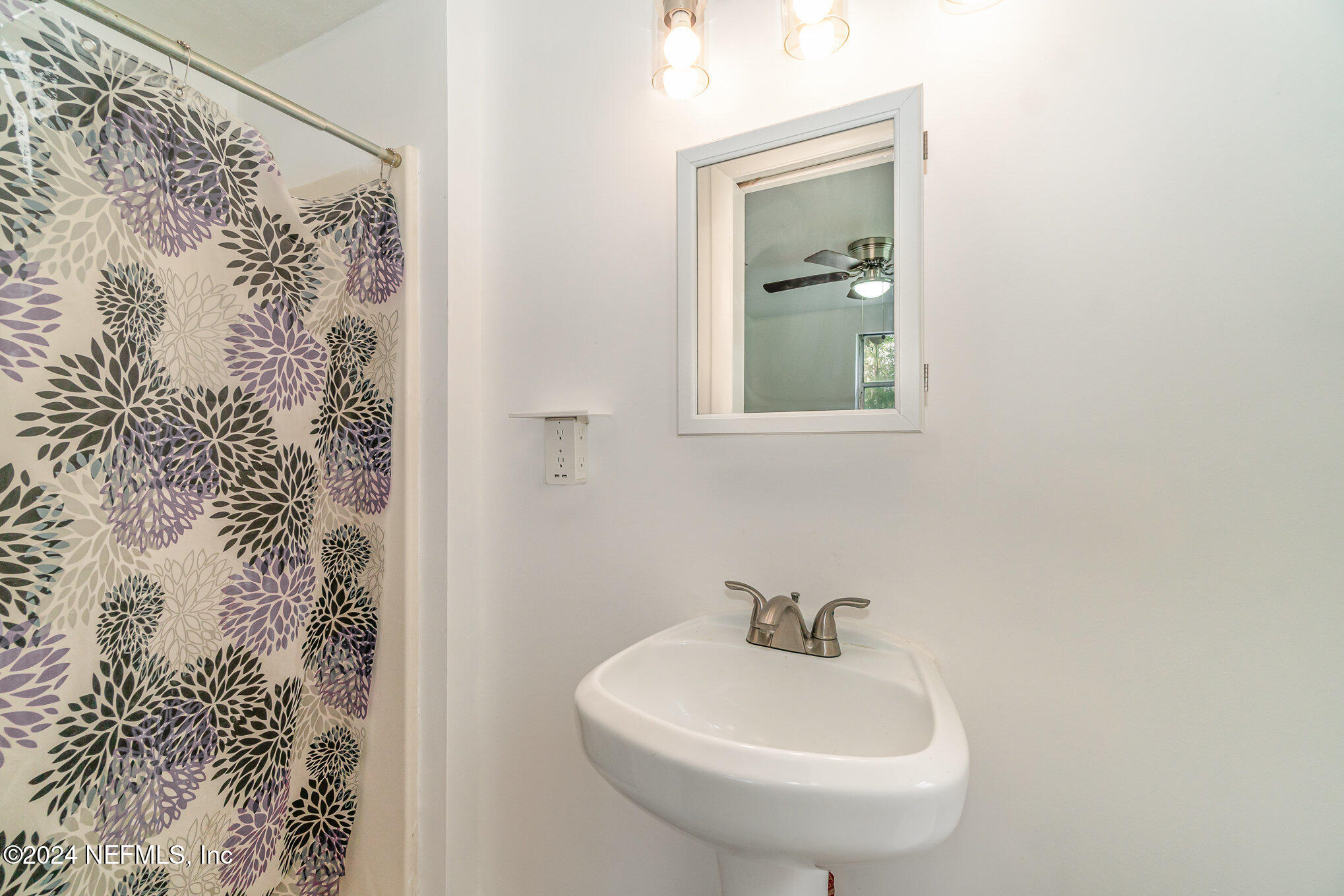 1108 Blair Road Jacksonville, FL 32221 - Photo 21 of 30 a bathroom with a sink and a mirror