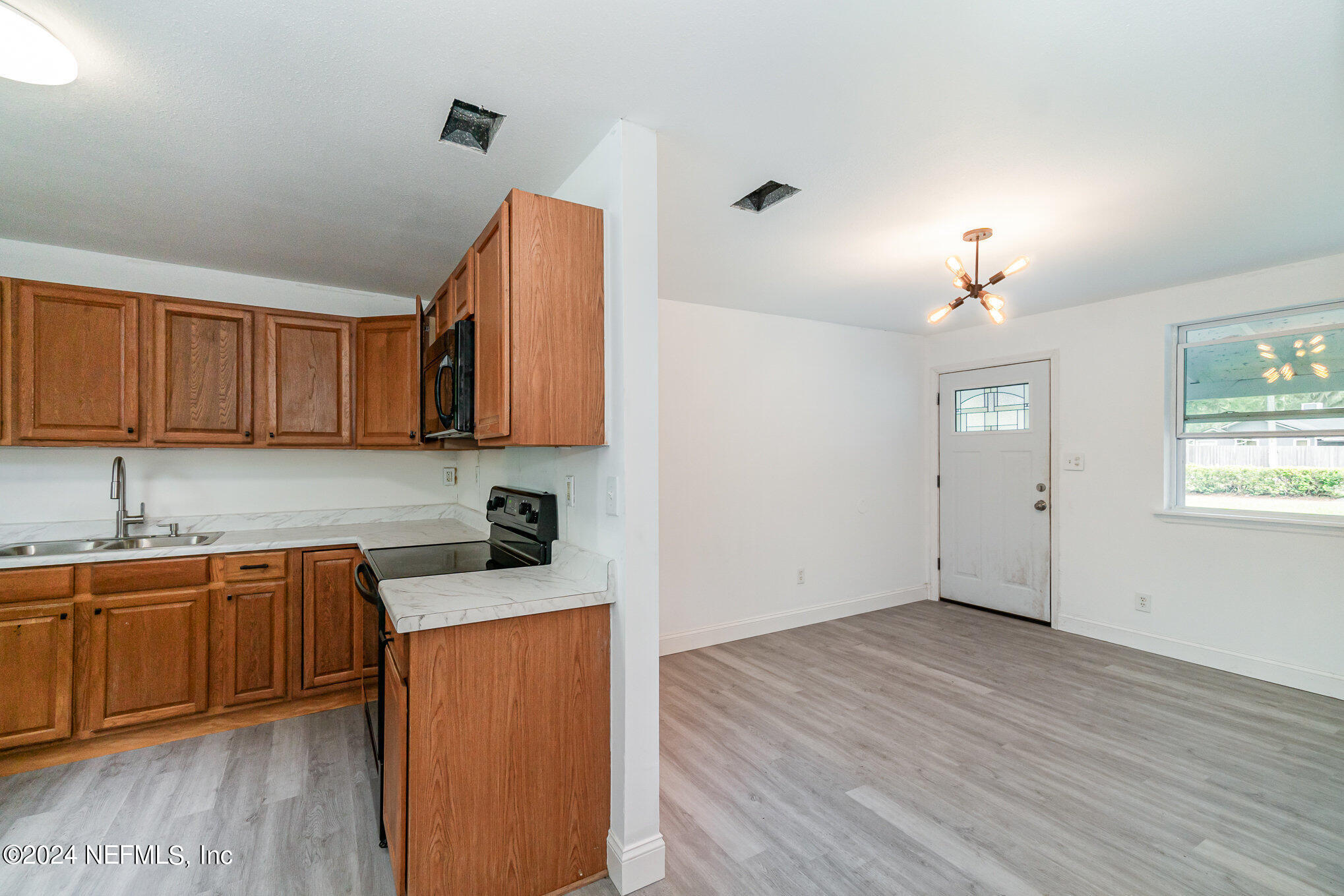 1108 Blair Road Jacksonville, FL 32221 - Photo 10 of 30 a view of a kitchen cabinets a sink and wooden floor