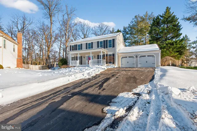 a view of a house with a yard covered in snow