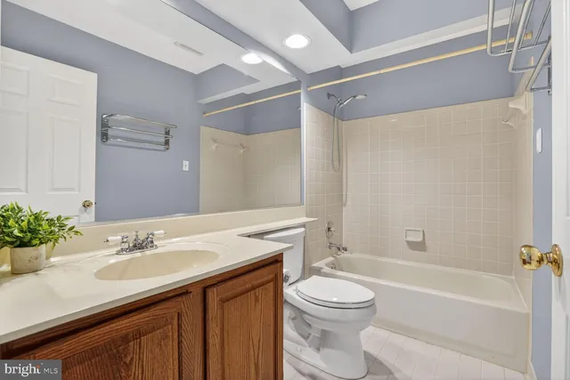 a bathroom with a sink vanity granite toilet tub and shower
