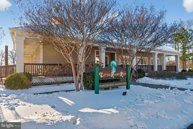 a view of a house with a tree in front of it