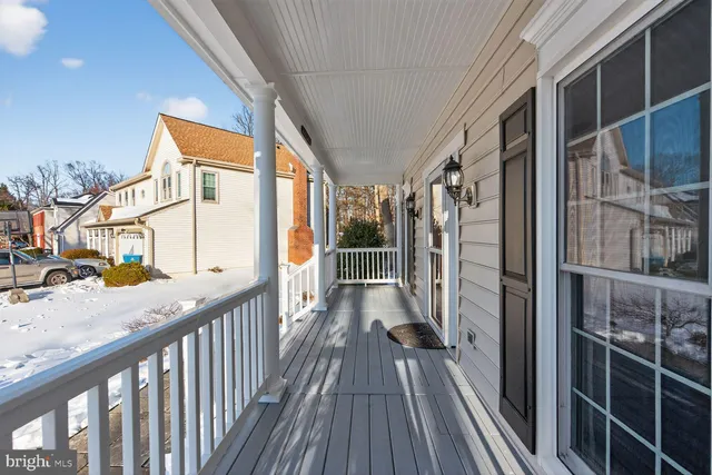 a view of front door with wooden floor and stairs