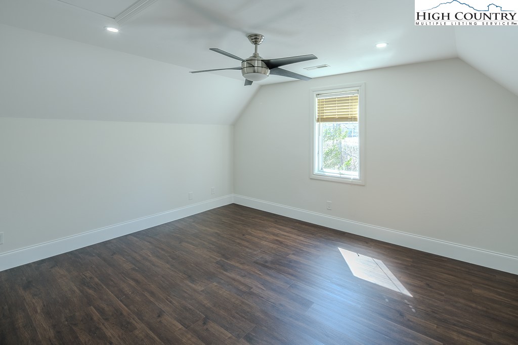330 North Pinnacle Ridge Road Beech Mountain, NC 28604 - Photo 28 of 38 an empty room with wooden floor fan and windows