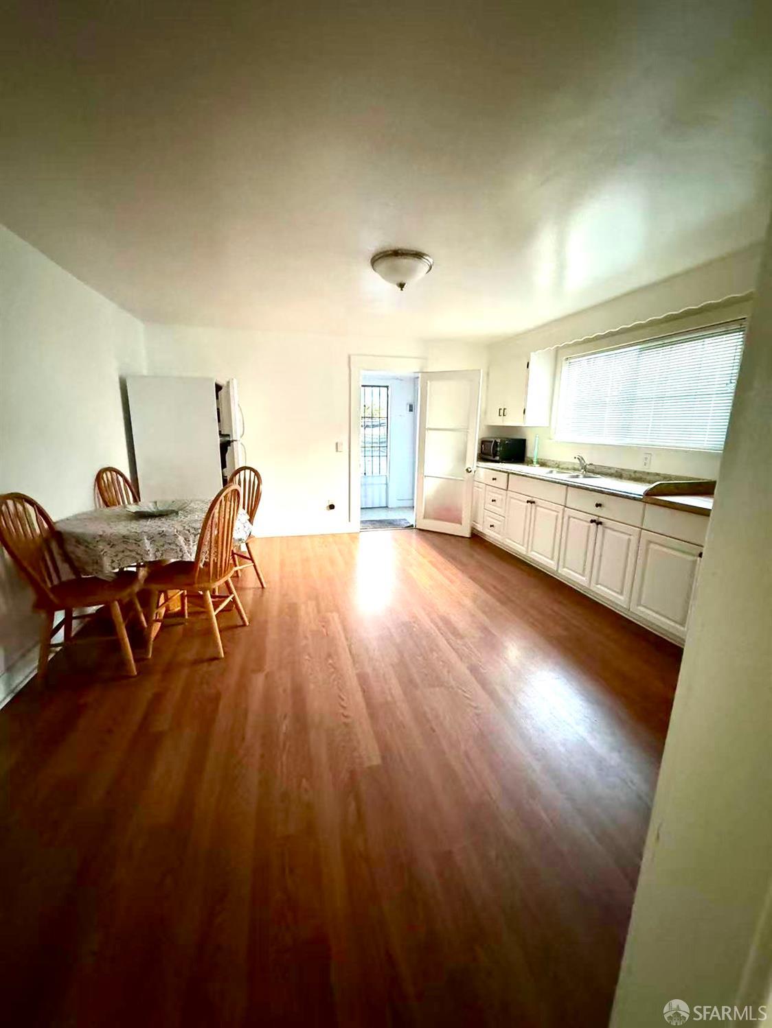 550 A Street Hayward, CA 94541 - Photo 9 of 14 a view of a kitchen with kitchen island wooden floors appliances and furniture
