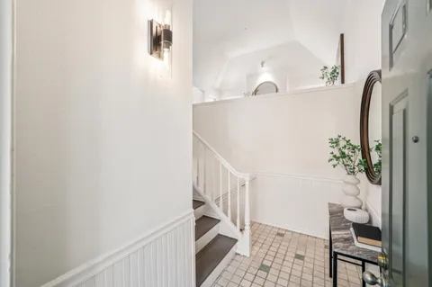 a view of entryway with furniture and wooden floor