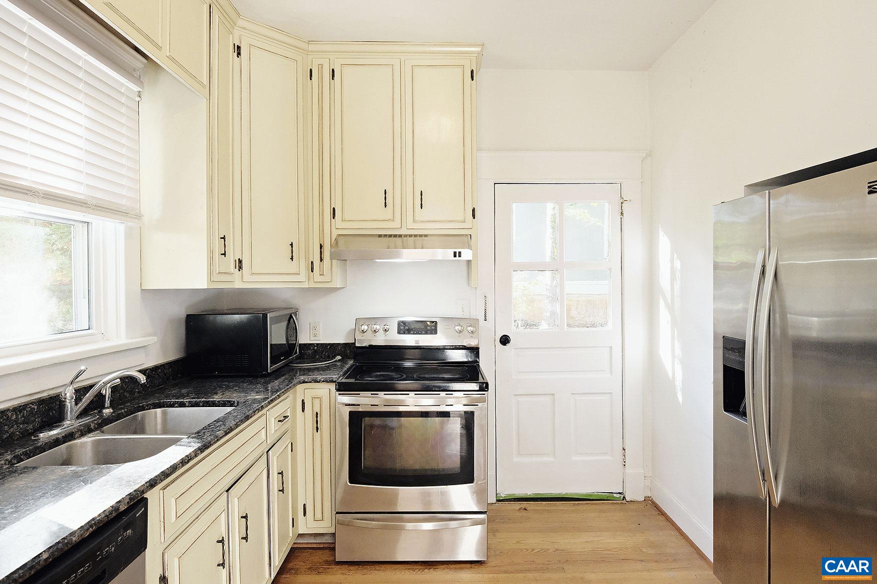 201 Cleveland Avenue Charlottesville, VA 22903 - Photo 2 of 15 a kitchen with a sink stove and refrigerator