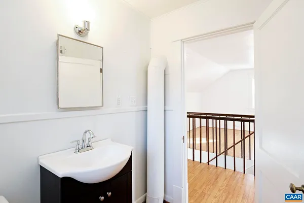 a bathroom with a sink a toilet and a window