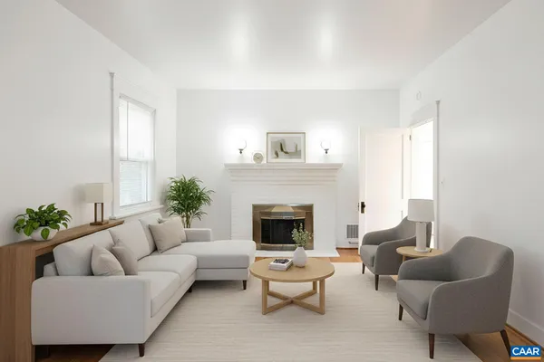 an empty room with wooden floor and fireplace