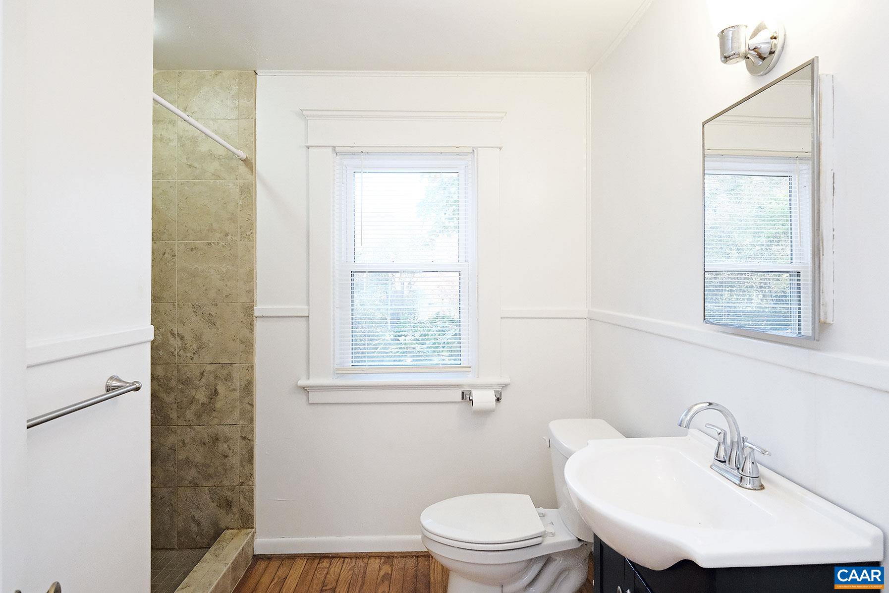 201 Cleveland Avenue Charlottesville, VA 22903 - Photo 9 of 15 a bathroom with a sink a toilet and a window