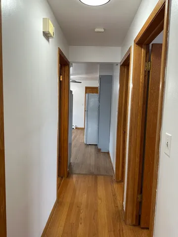 a view of a hallway with wooden floor
