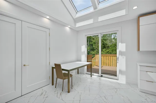 a view of a livingroom with furniture and a window