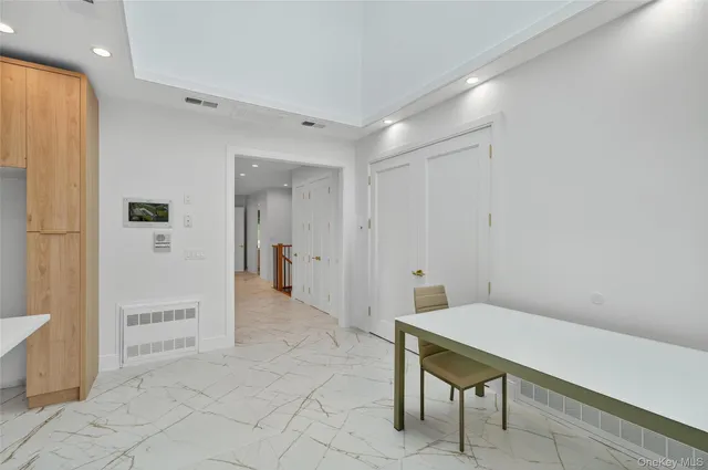 a living room with stainless steel appliances furniture and a open kitchen view