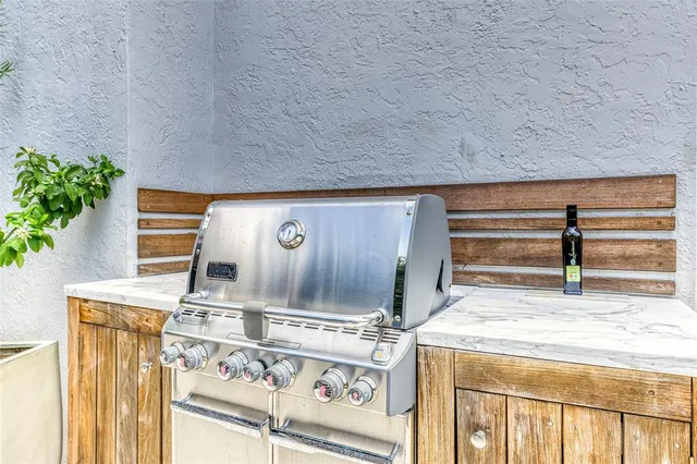 a front view of a house with garden and trees